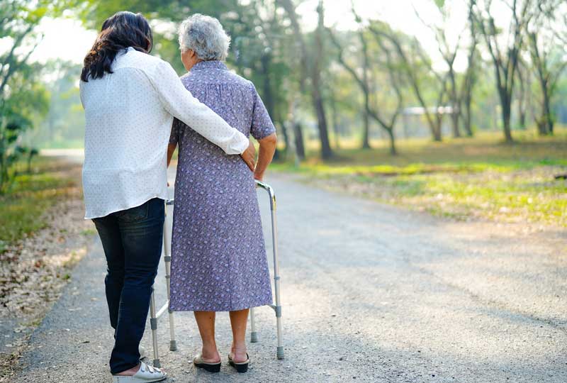 Carer Helping Old Woman