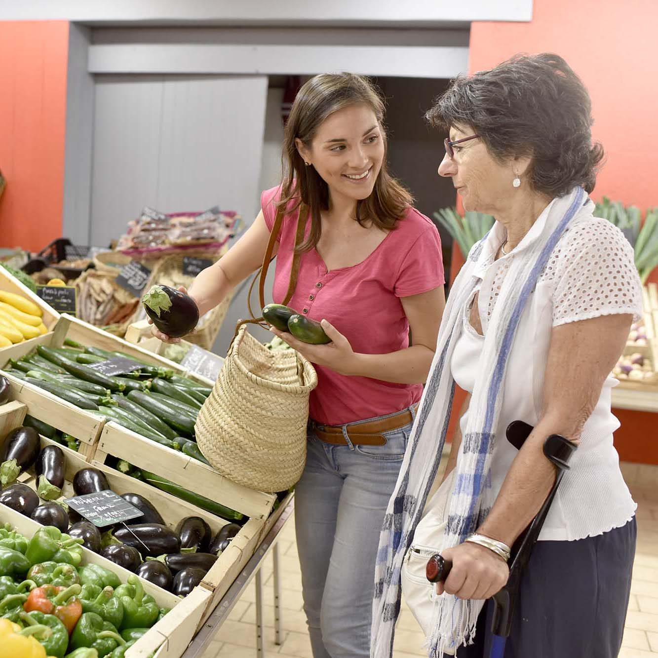 Senior woman going to grocery store with help of carer