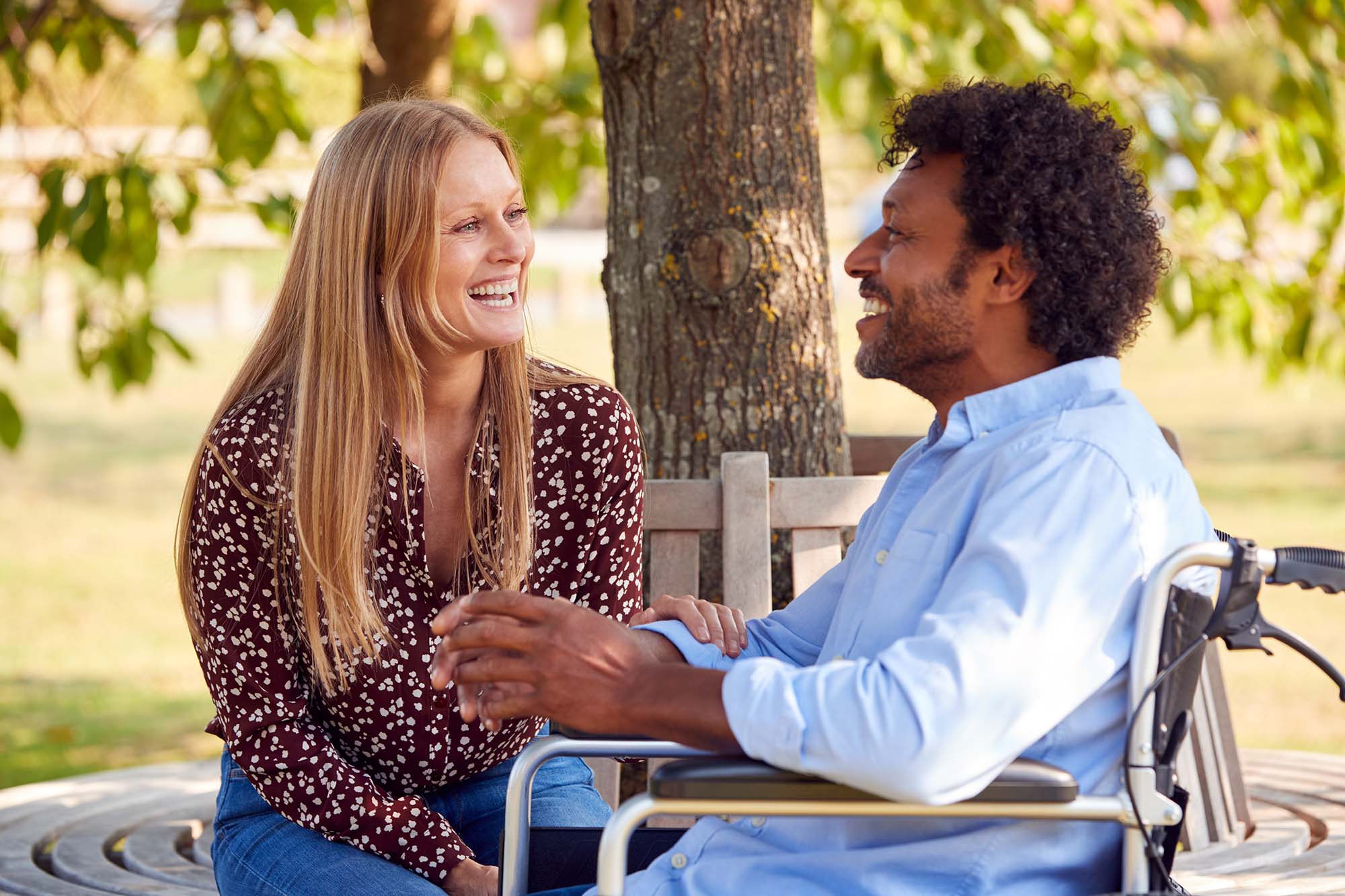 Disabled man being assisted by carer